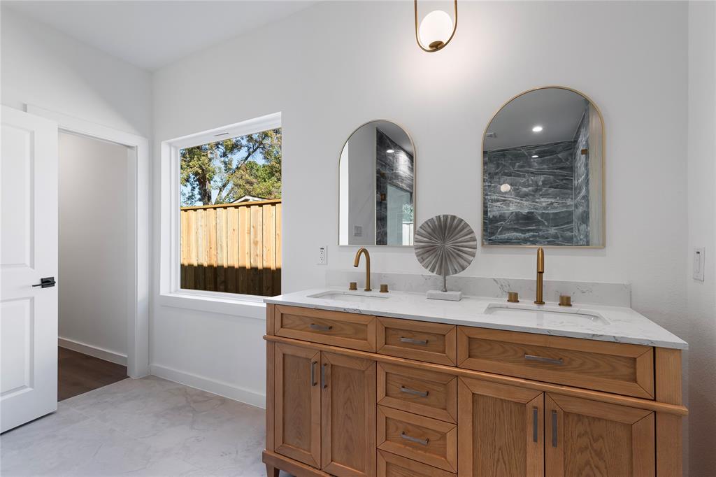 2535 Exline Street Dallas, TX 75215 - Photo 30 of 38 a bathroom with a double vanity sink and a window