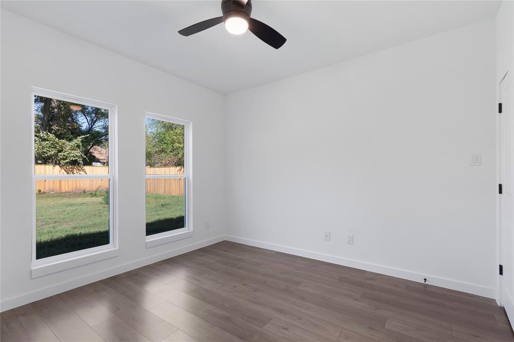 2535 Exline Street Dallas, TX 75215 - Photo 35 of 38 an empty room with wooden floor and windows