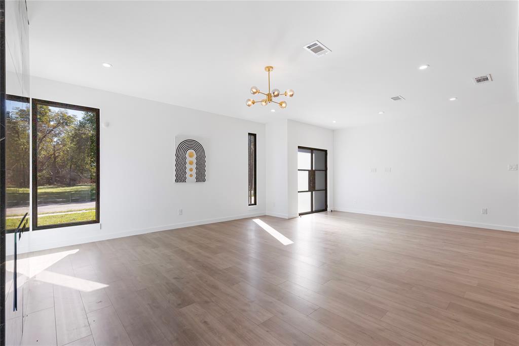 2535 Exline Street Dallas, TX 75215 - Photo 10 of 38 a view of an empty room with window and wooden floor