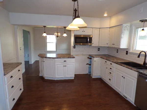 a kitchen with cabinets and window