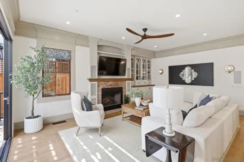 a living room with fireplace furniture and a flat screen tv