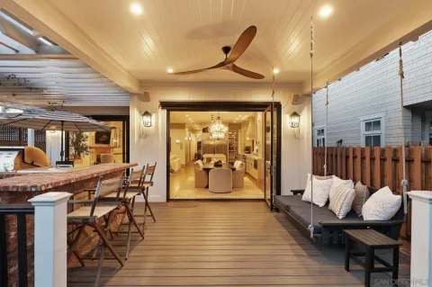 a view of a patio with table and chairs potted plants with floor to ceiling window and wooden floor