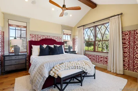 a spacious bedroom with a large bed and large windows