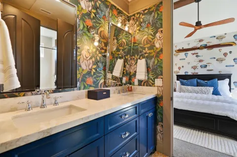 a bathroom with a double vanity sink and a mirror