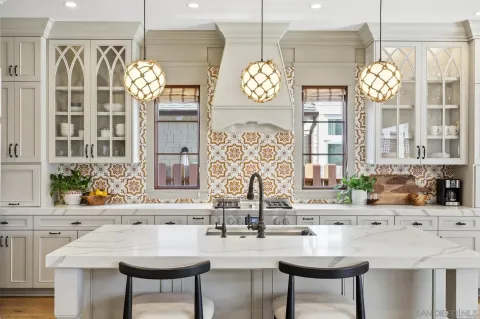 a kitchen with stainless steel appliances granite countertop a sink a stove and a wooden floors