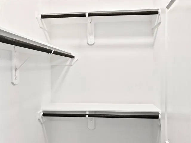 a bathroom with double sink and a large mirror