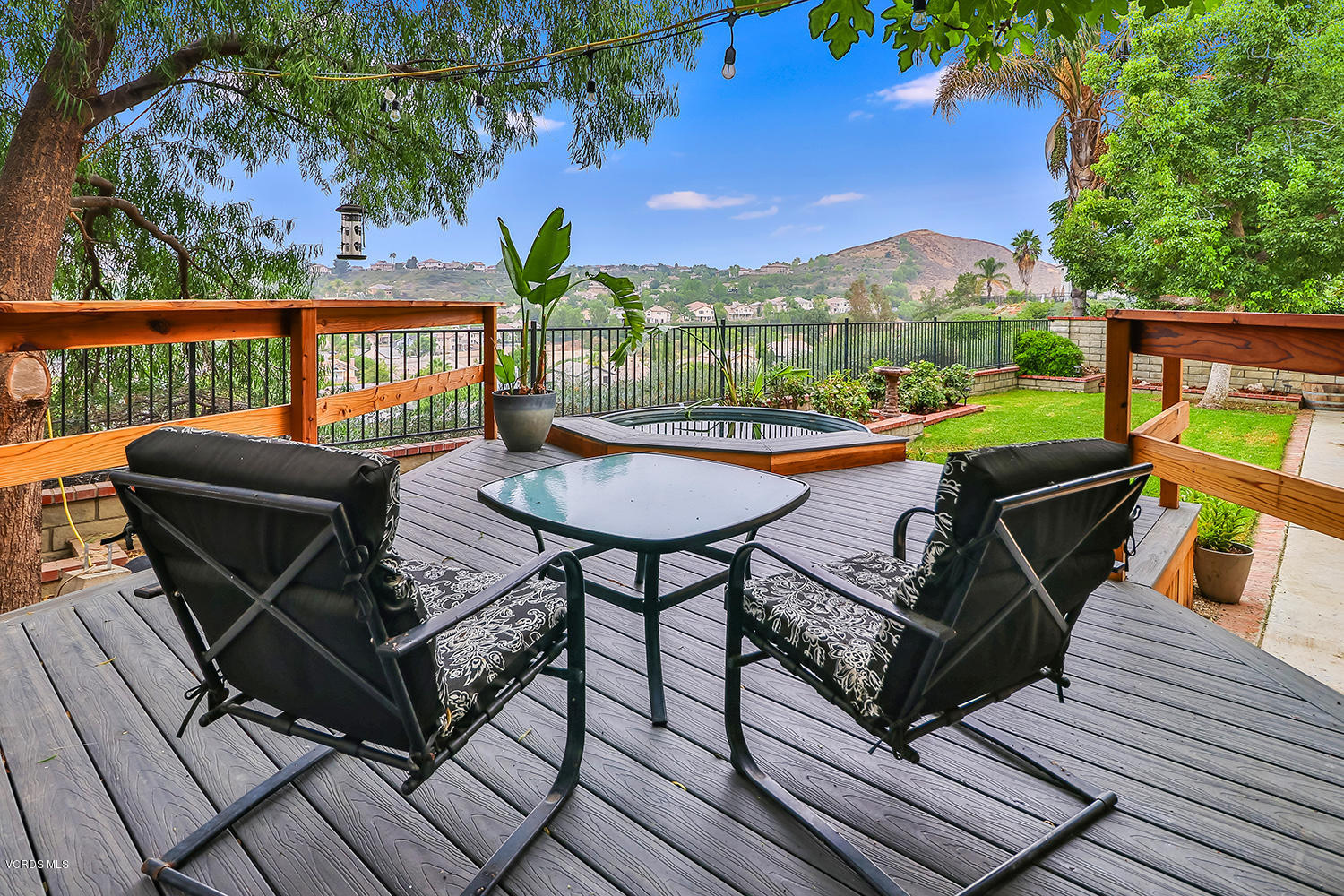a view of a chairs and table in patio with a barbeque grill