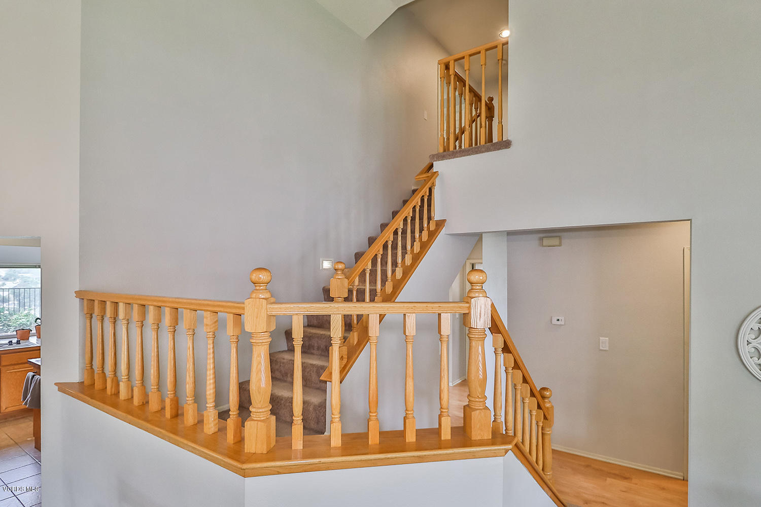 29009 Gumtree Place Saugus, CA 91390 - Photo 27 of 66 a view of staircase with lots of frames on wall and wooden floor