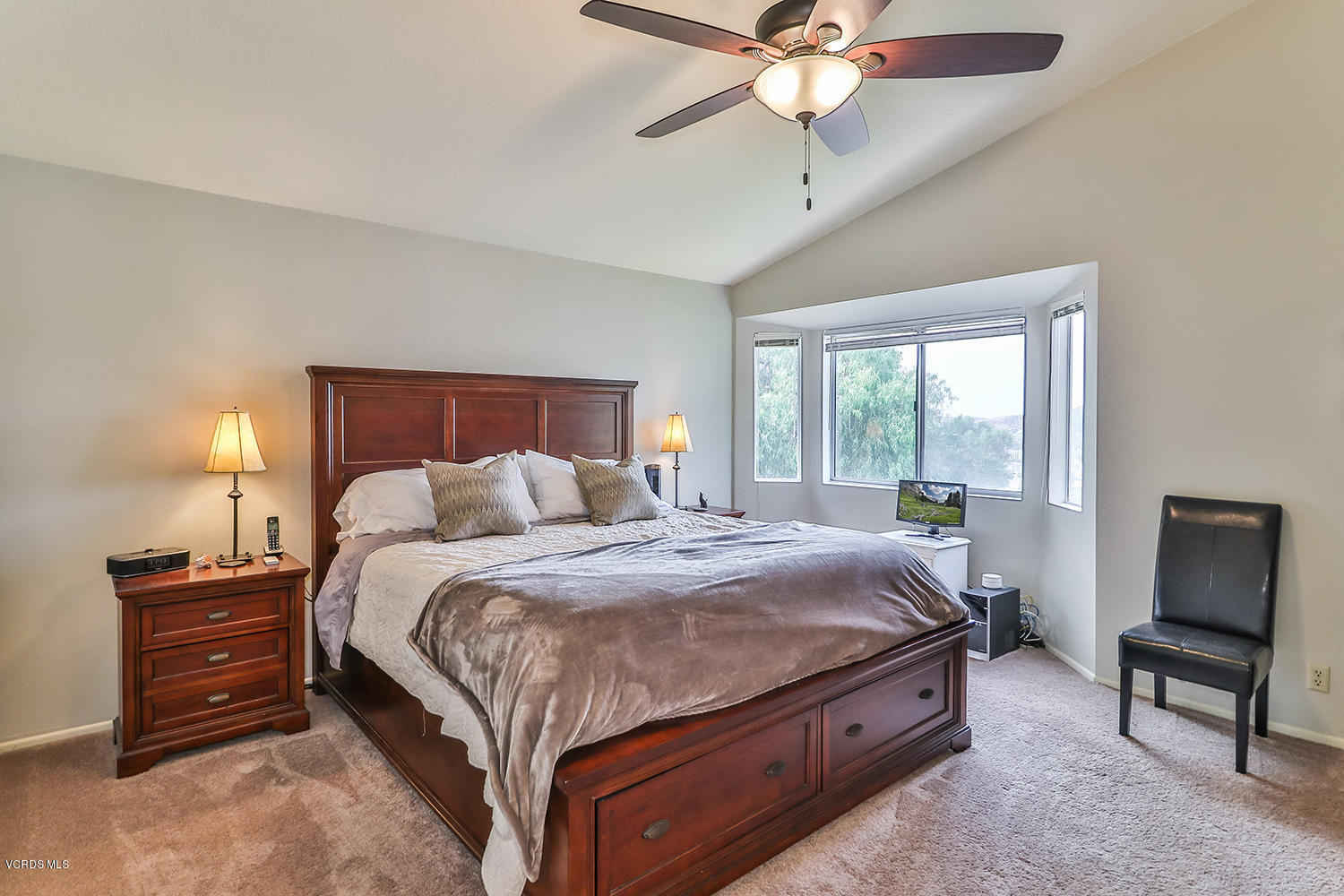 29009 Gumtree Place Saugus, CA 91390 - Photo 37 of 66 a bedroom with a bed a chandelier and a flat tv screen on dresser