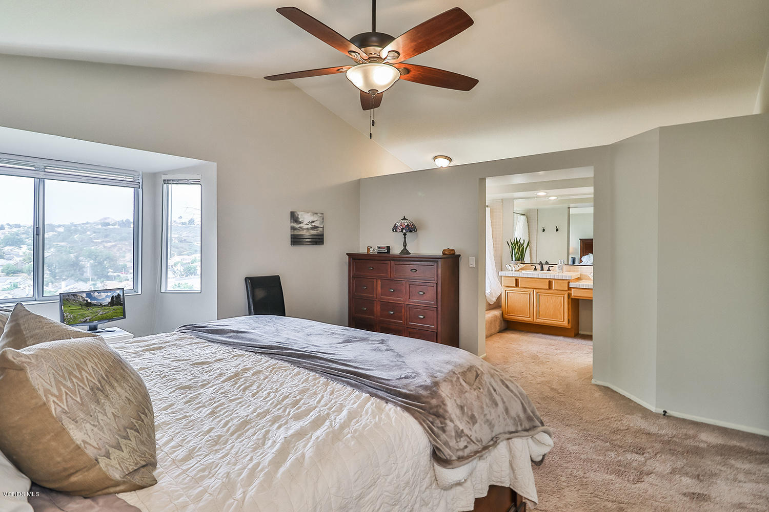 29009 Gumtree Place Saugus, CA 91390 - Photo 38 of 66 a bedroom with a large bed and a chandelier