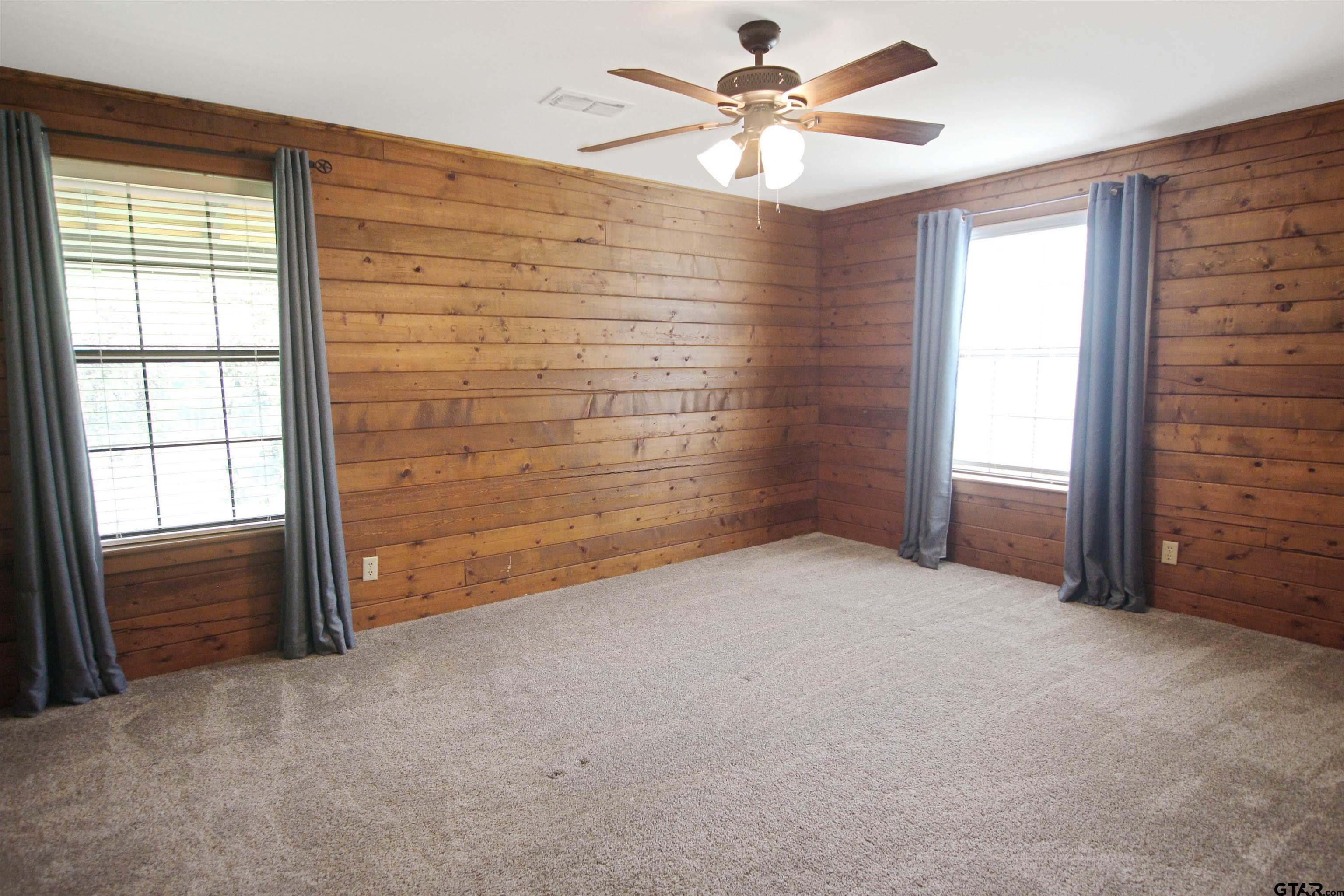 782 Rosie Wady Road Gladewater, TX 75647 - Photo 16 of 48 an empty room with windows and fan