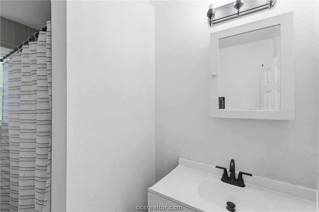 408 Hill Street Bryan, TX 77803 - Photo 34 of 50 a bathroom with a sink and a mirror