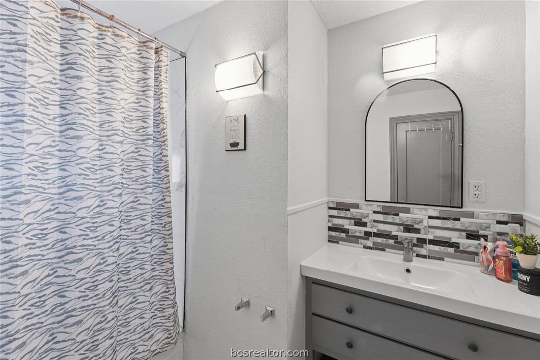 408 Hill Street Bryan, TX 77803 - Photo 37 of 50 a bathroom with a sink a mirror and shower