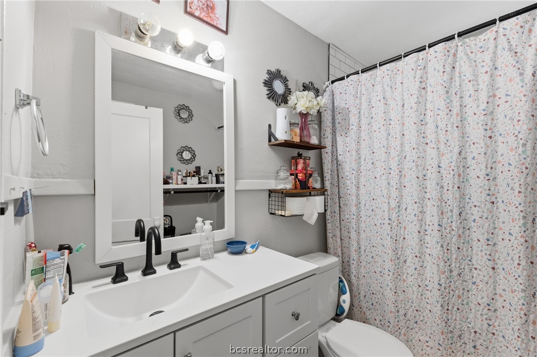 408 Hill Street Bryan, TX 77803 - Photo 38 of 50 a bathroom with a sink vanity mirror and toilet