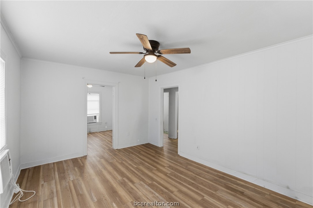 408 Hill Street Bryan, TX 77803 - Photo 8 of 50 a view of a room with wooden floor and a ceiling fan