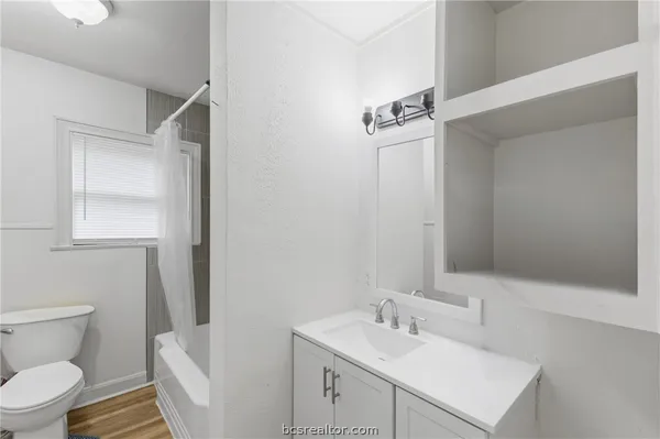 an empty room with a window and a ceiling fan