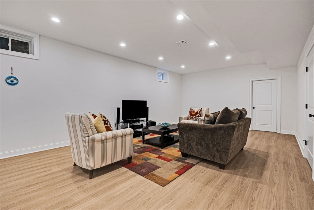 17 Sunrise Terrace Needham, MA 02492 - Photo 32 of 42 a living room with furniture and a flat screen tv