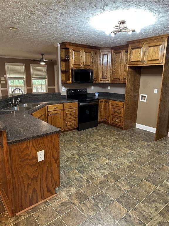 2683 Greer Road Hillsboro, GA 31038 - Photo 6 of 18 a kitchen with granite countertop a stove a sink a refrigerator and cabinets