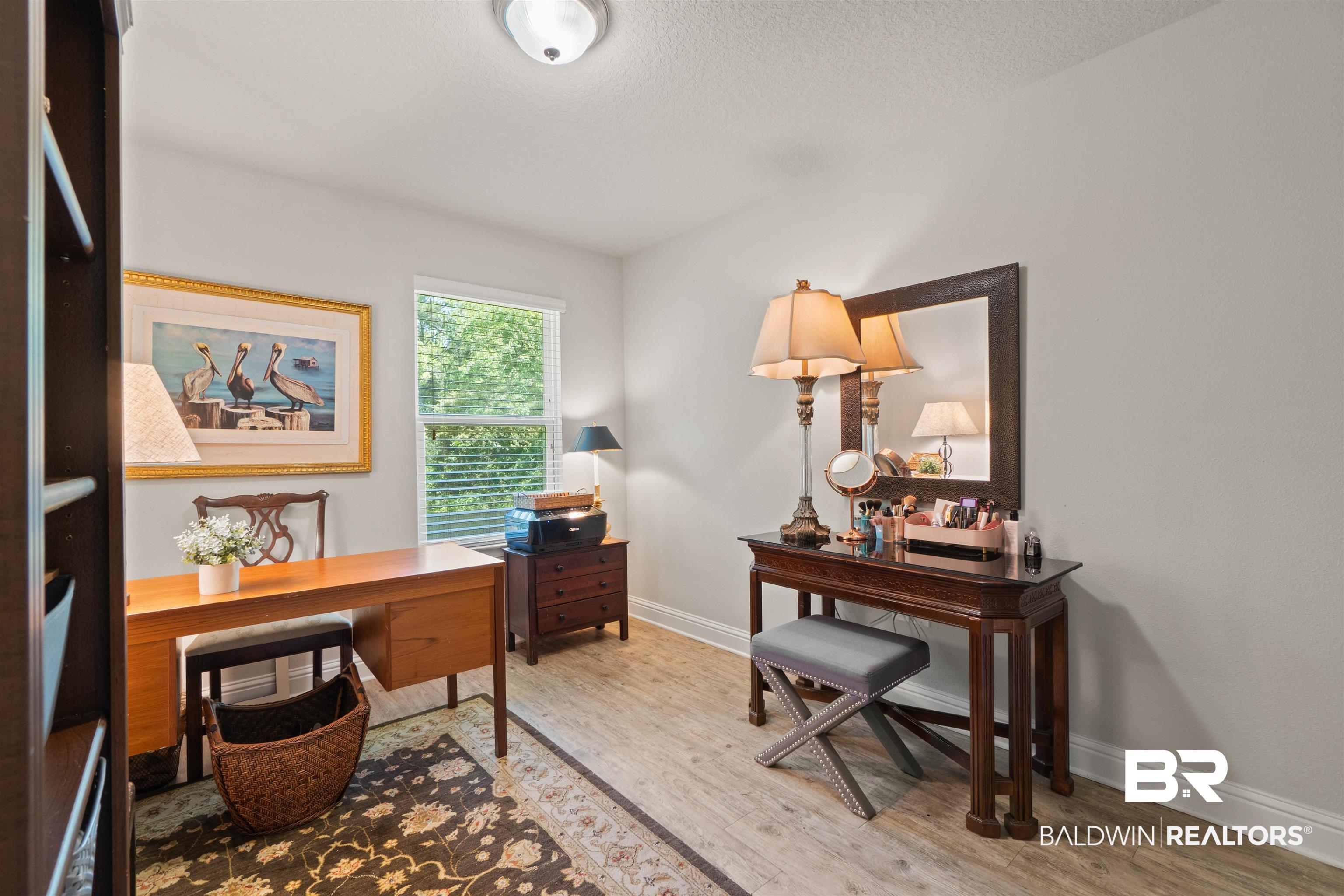 25806 Pollard Road, Unit 6 Daphne, AL 36526 - Photo 16 of 38 Bright room featuring light wood-finish flooring, a single window with horizontal blinds, and light-colored walls