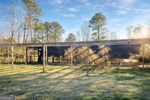 a front view of a building with lots of trees
