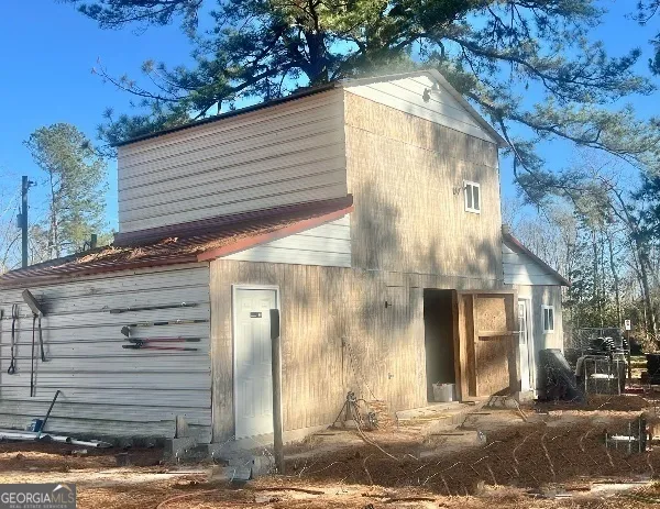 a view of a house with backyard porch and sitting area