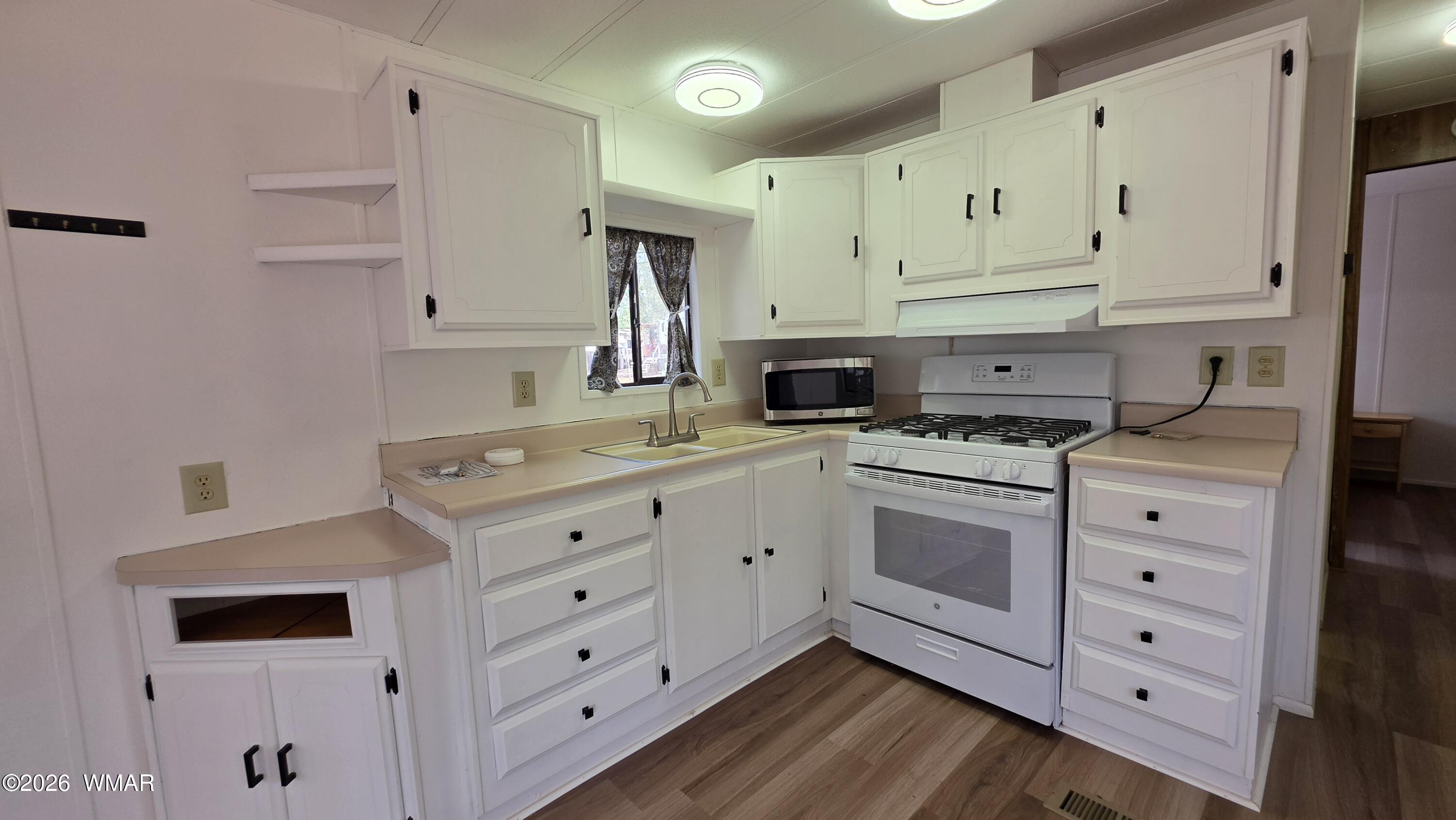 2468 Running Bear Road, Unit 44 Lakeside, AZ 85929 - Photo 7 of 11 a kitchen with cabinets appliances a sink and a window