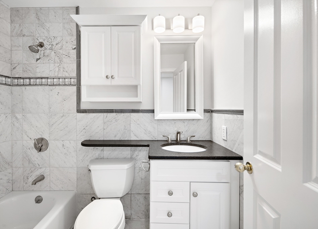 4 Charlesgate East, Unit 201 Boston, MA 02215 - Photo 11 of 32 a bathroom with a sink a toilet and shower