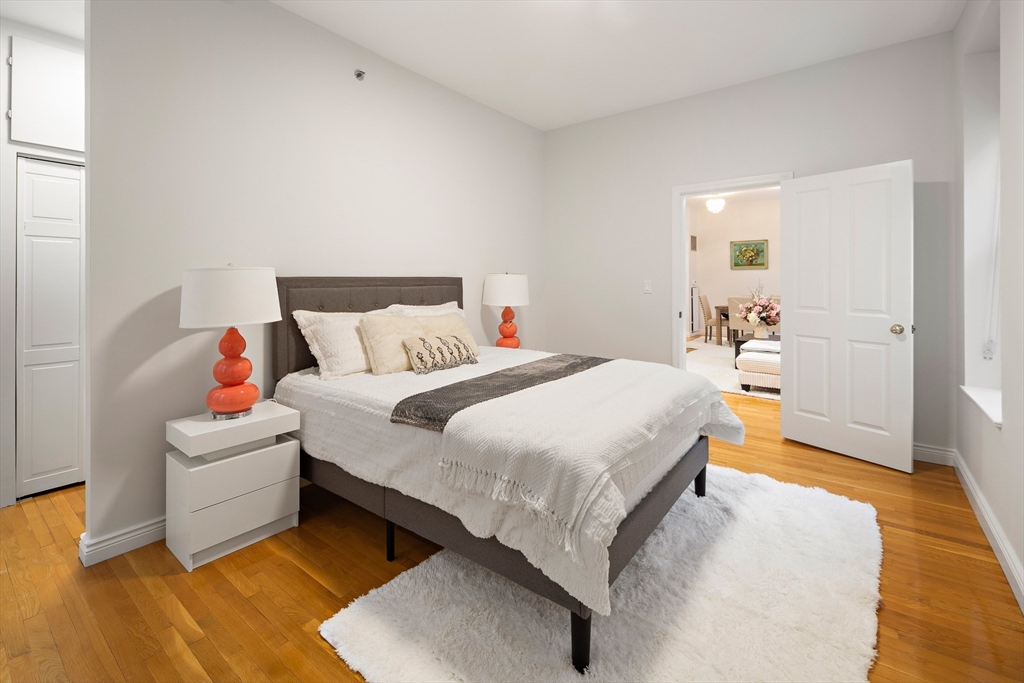 4 Charlesgate East, Unit 201 Boston, MA 02215 - Photo 12 of 30 a bedroom with a bed and wooden floor