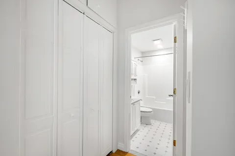 a bathroom with a toilet and a shower