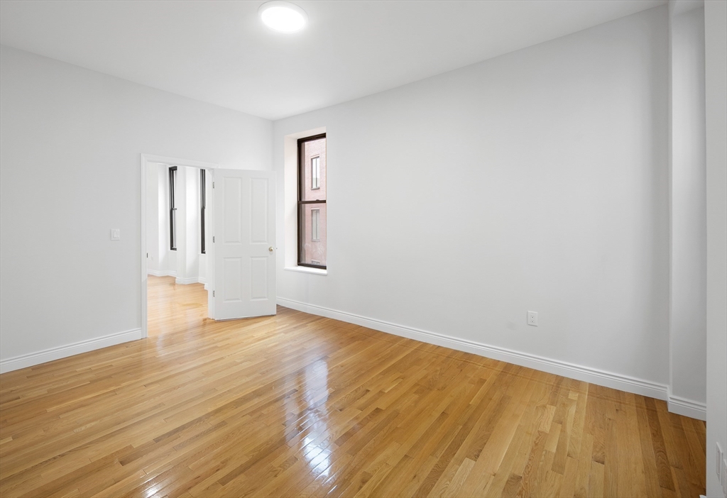 4 Charlesgate East, Unit 201 Boston, MA 02215 - Photo 16 of 32 a view of an empty room with wooden floor and a window