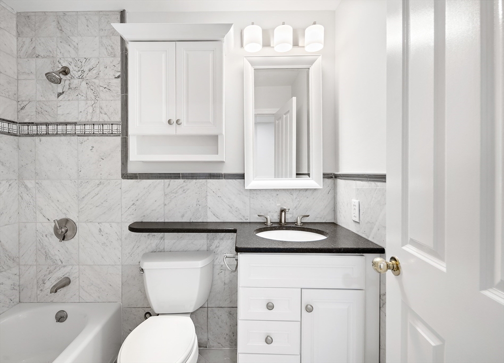 4 Charlesgate East, Unit 201 Boston, MA 02215 - Photo 17 of 30 a bathroom with a sink a toilet and shower