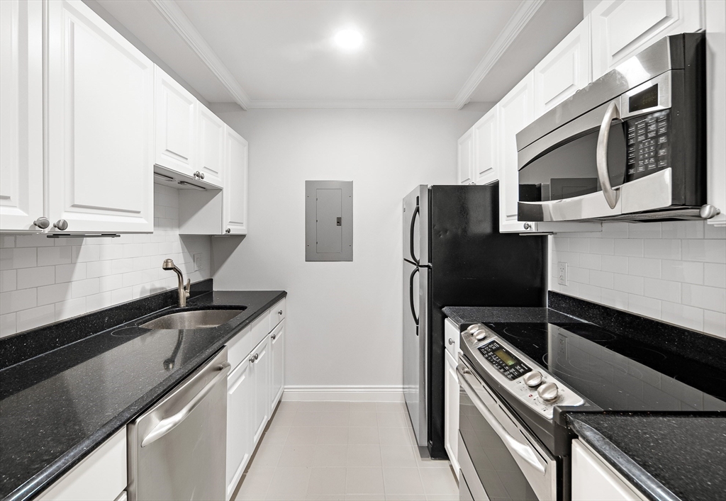 4 Charlesgate East, Unit 201 Boston, MA 02215 - Photo 20 of 30 a kitchen with stainless steel appliances a sink stove and refrigerator