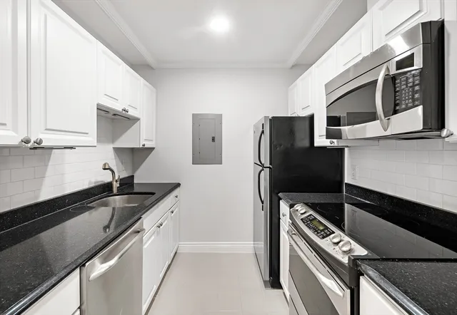 a kitchen with stainless steel appliances a sink stove and refrigerator