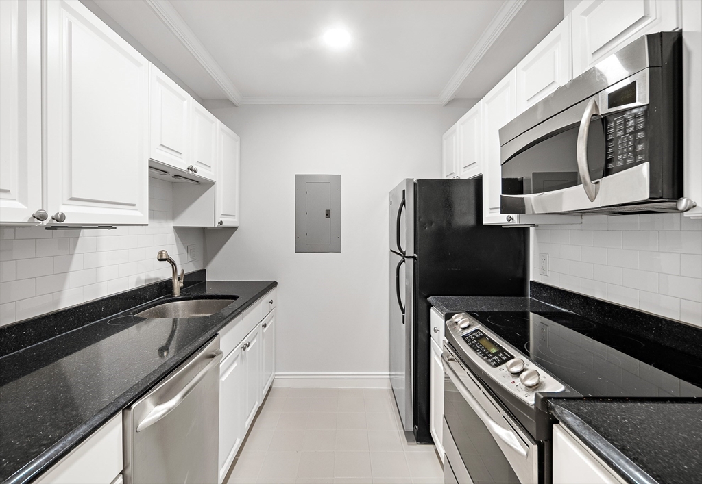 4 Charlesgate East, Unit 201 Boston, MA 02215 - Photo 20 of 32 a kitchen with stainless steel appliances a sink stove and refrigerator