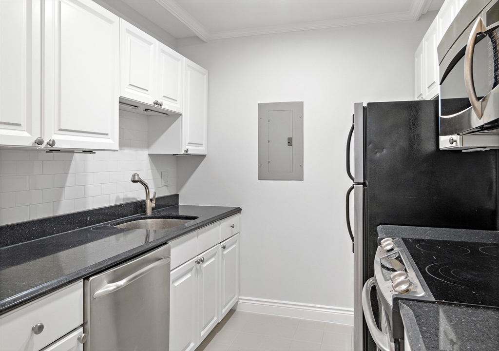 4 Charlesgate East, Unit 201 Boston, MA 02215 - Photo 21 of 32 a kitchen with a sink appliances and cabinets
