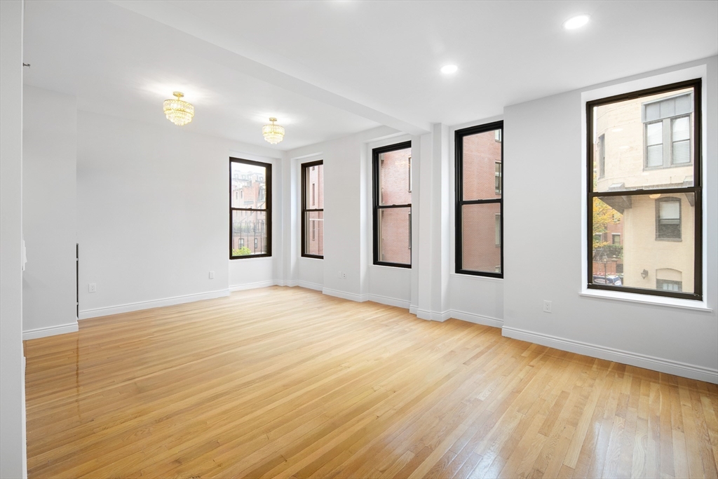 4 Charlesgate East, Unit 201 Boston, MA 02215 - Photo 3 of 32 a view of an empty room with wooden floor and a window