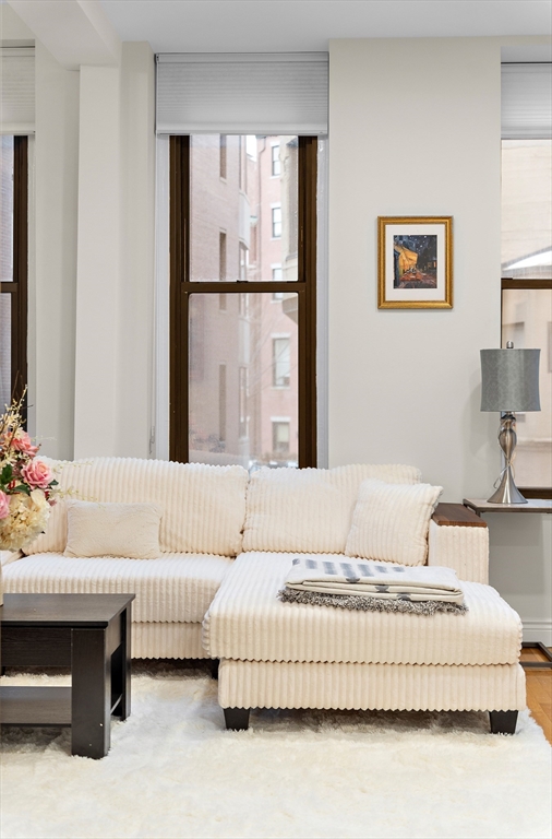 4 Charlesgate East, Unit 201 Boston, MA 02215 - Photo 6 of 30 a bedroom with a bed and a couch