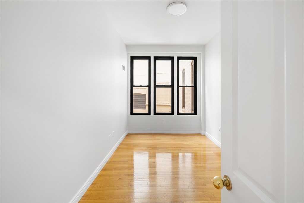 4 Charlesgate East, Unit 201 Boston, MA 02215 - Photo 7 of 32 a view of a big room with windows
