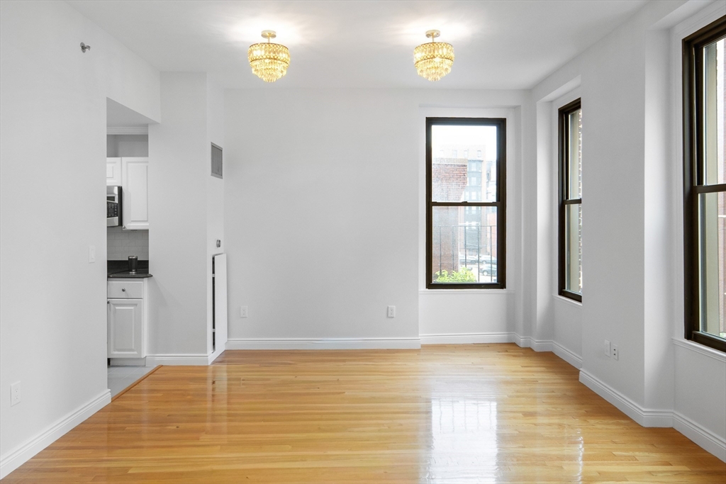 4 Charlesgate East, Unit 201 Boston, MA 02215 - Photo 8 of 30 a view of an empty room with window and wooden floor