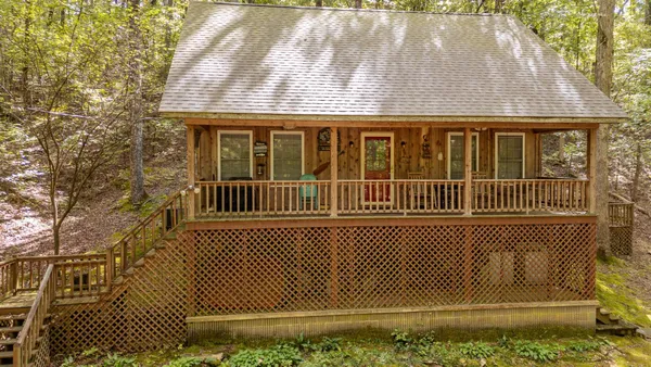 a view of a house with a wooden deck