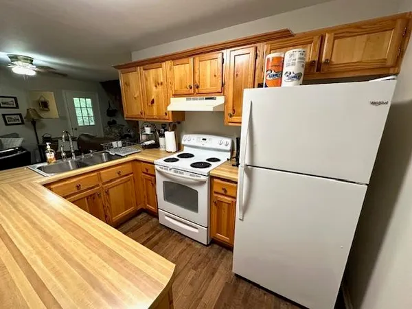 a kitchen with sink a stove and cabinets
