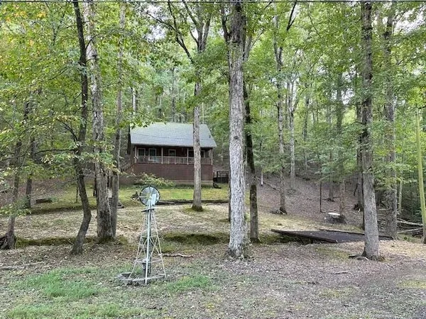 a backyard of a house with barbeque oven table and chairs