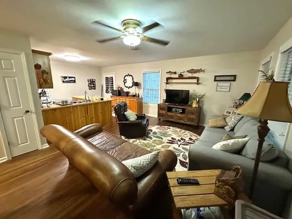 a living room with furniture a fireplace and a flat screen tv
