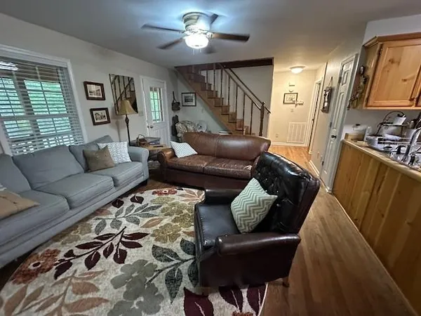 a living room with furniture and wooden floor