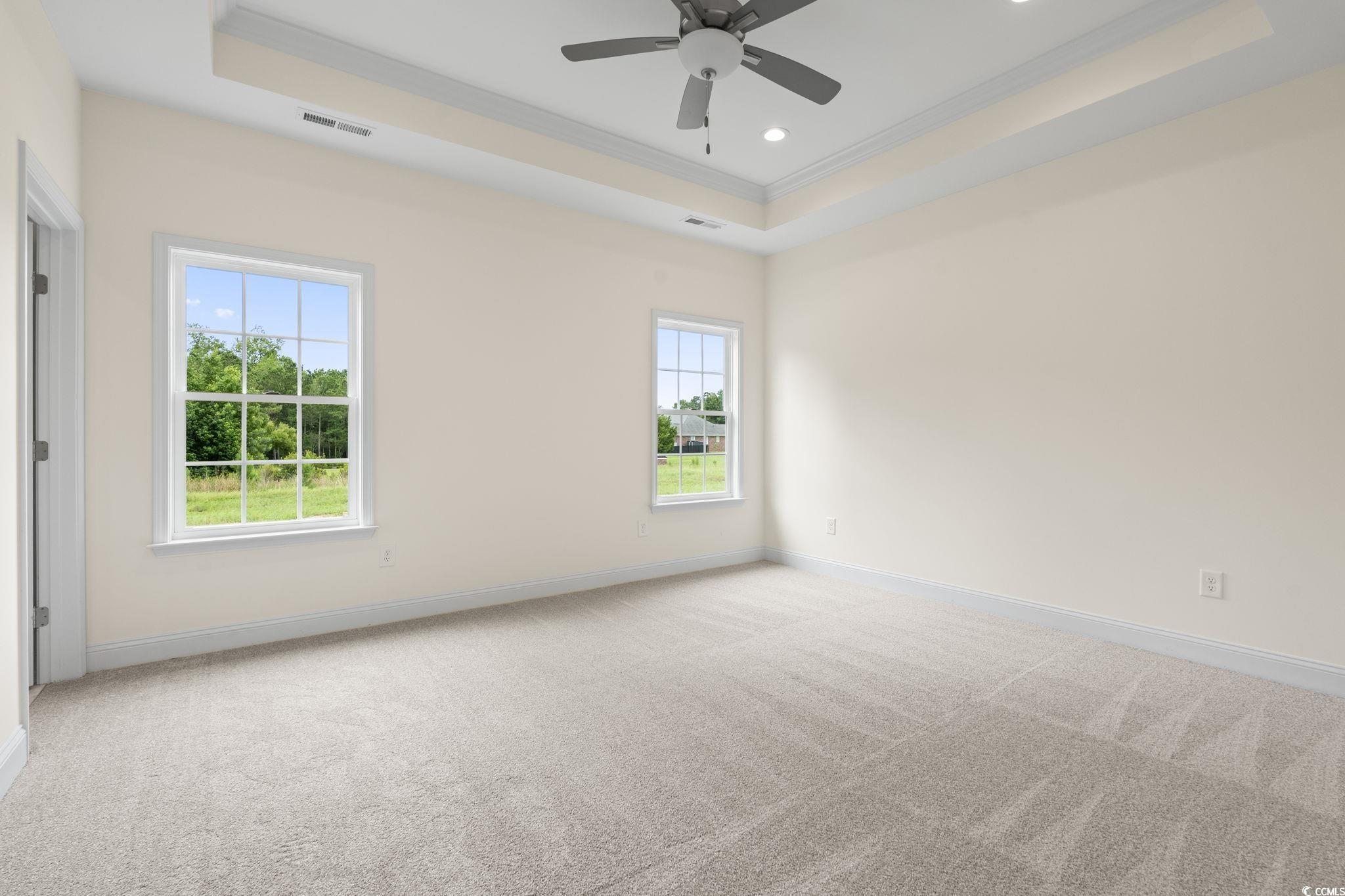 108 Infinity Lane Loris, SC 29569 - Photo 20 of 35 Carpeted primary bedroom with crown molding, a tra