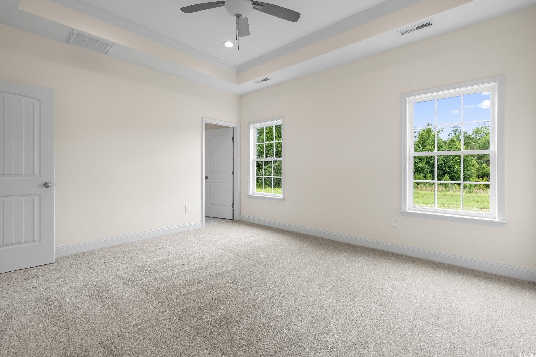 108 Infinity Lane Loris, SC 29569 - Photo 23 of 35 Carpeted primary bedroom with ornamental molding,