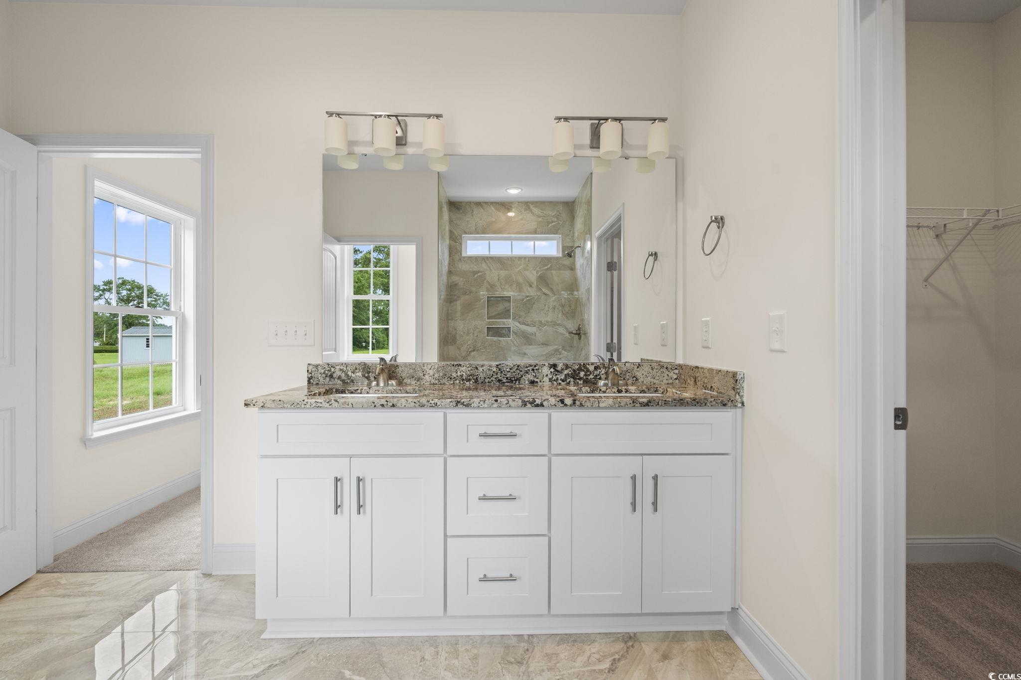 108 Infinity Lane Loris, SC 29569 - Photo 24 of 35 Bathroom featuring double vanity, tiled shower, a