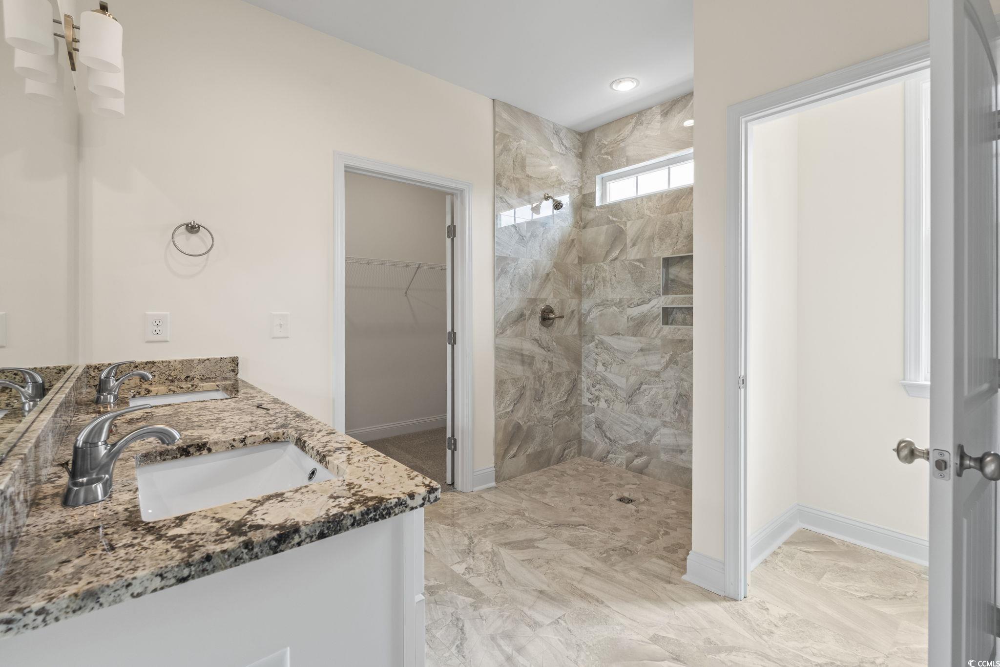 108 Infinity Lane Loris, SC 29569 - Photo 25 of 35 Primary Bathroom featuring a walk in shower, marbl
