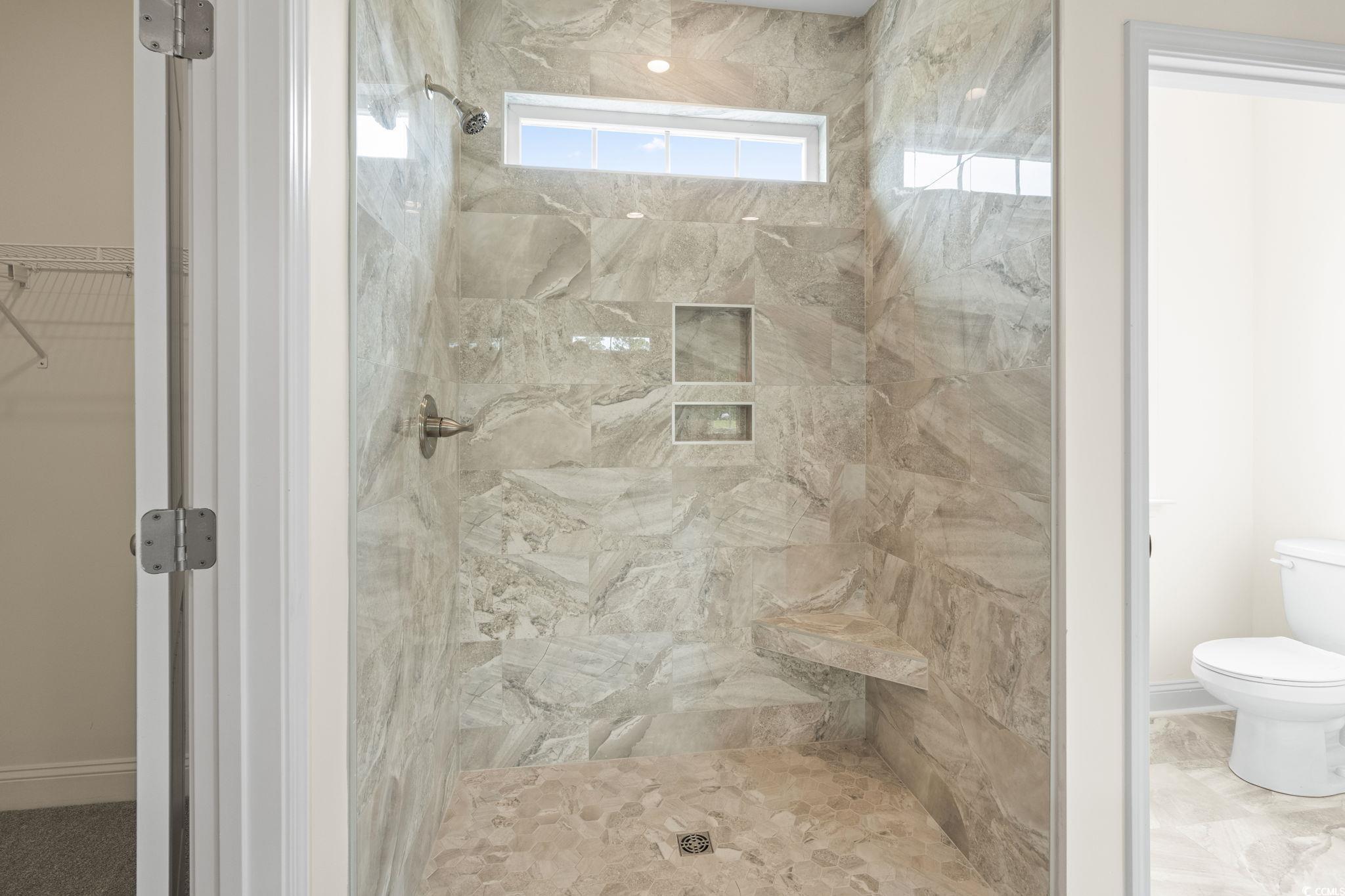 108 Infinity Lane Loris, SC 29569 - Photo 26 of 35 Bathroom featuring toilet and a tile shower