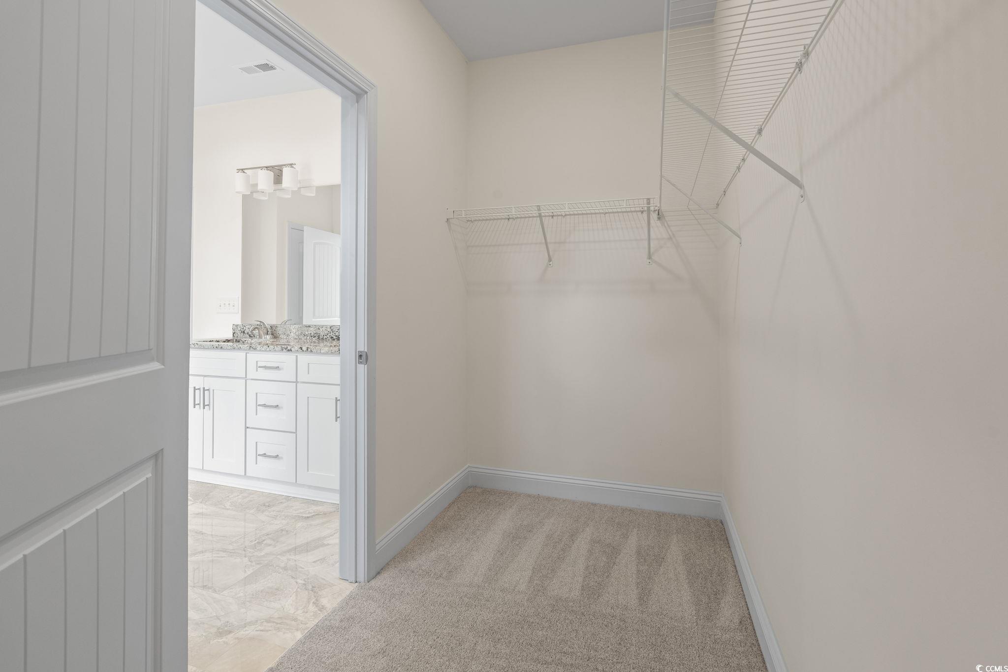 108 Infinity Lane Loris, SC 29569 - Photo 27 of 35 Primary Walk-In Closet inside the Primary Bathroom